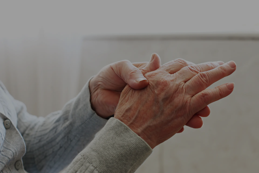 Elderly woman applying moisturizing lotion cream on hand palm, easing aches. Senior old lady experiencing severe arthritis rheumatics pains, massaging, warming up arm
